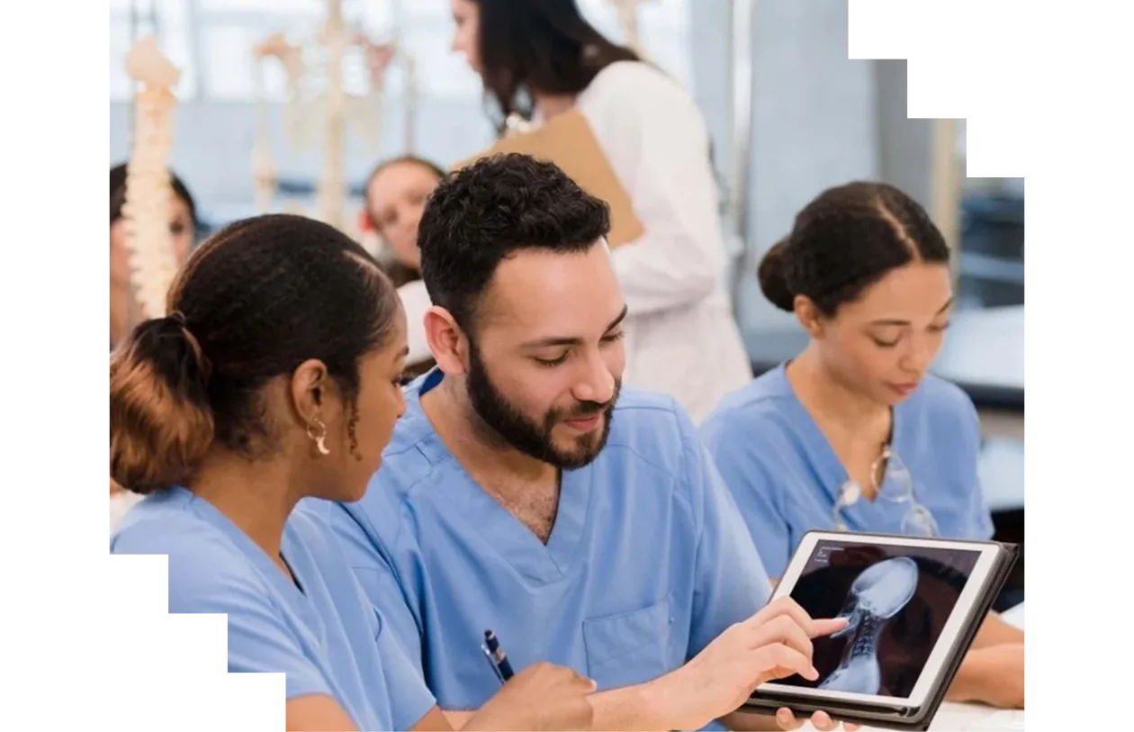 Medical students analyzing an x-ray on a digital tablet