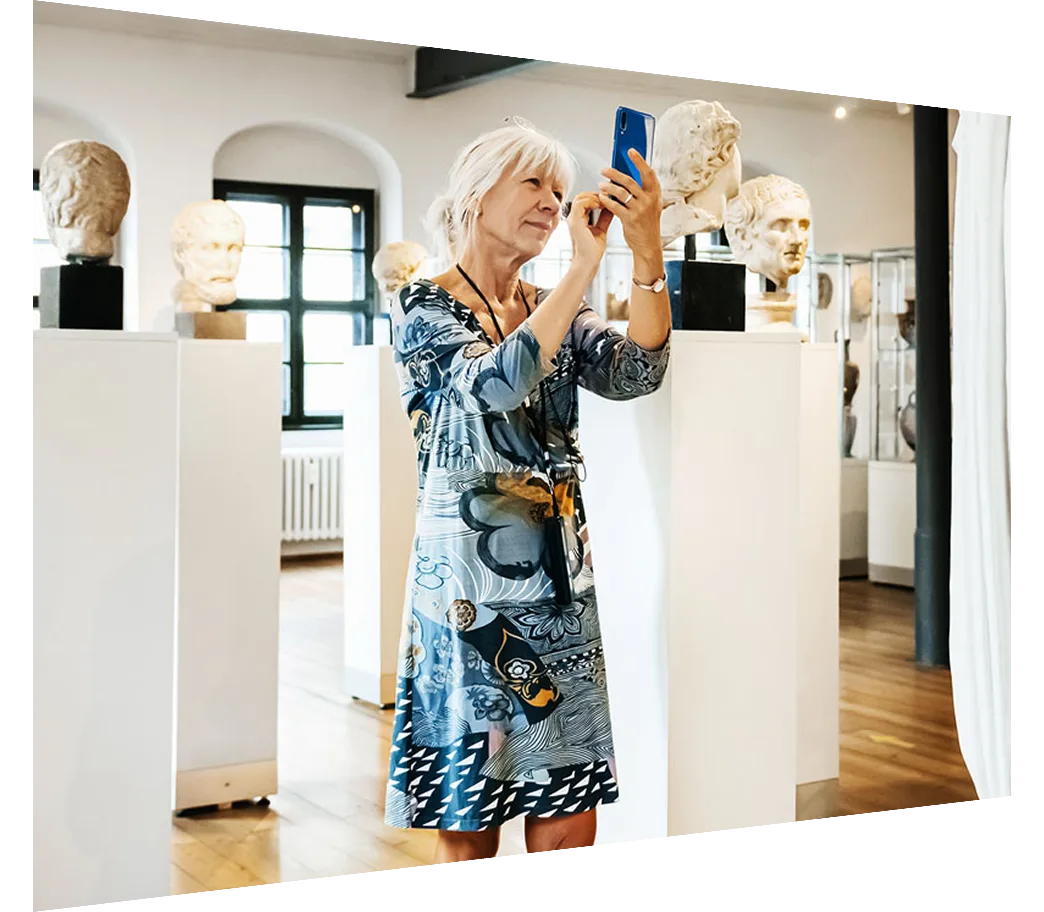Woman Taking Pictures Of Sculptures In Historical Museum