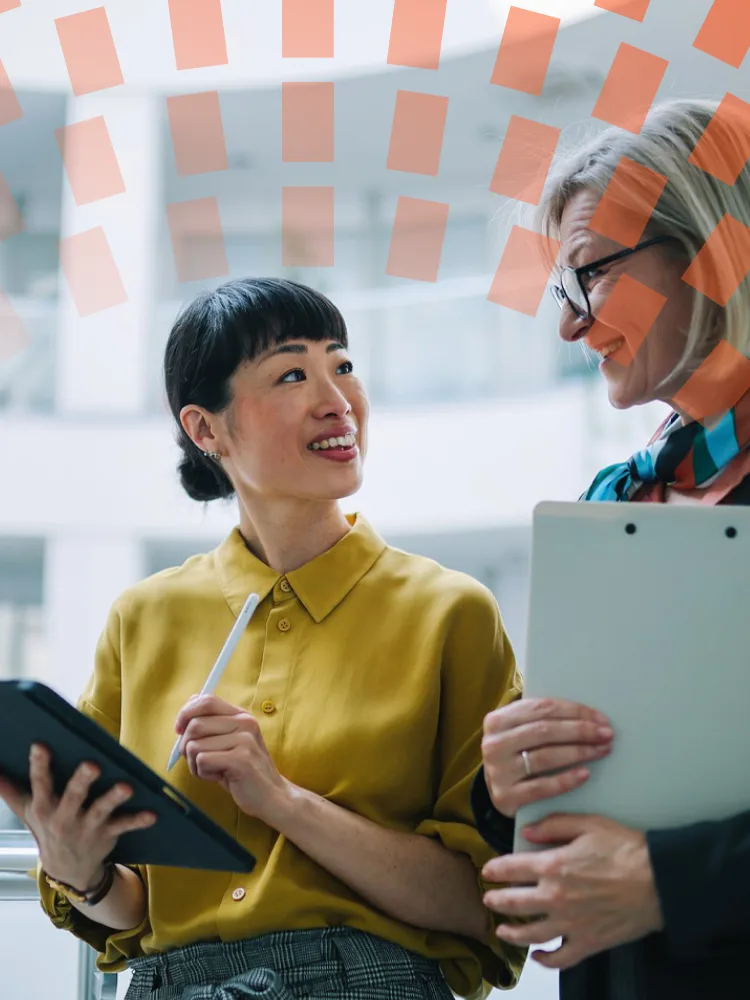 Two colleagues chatting and walking