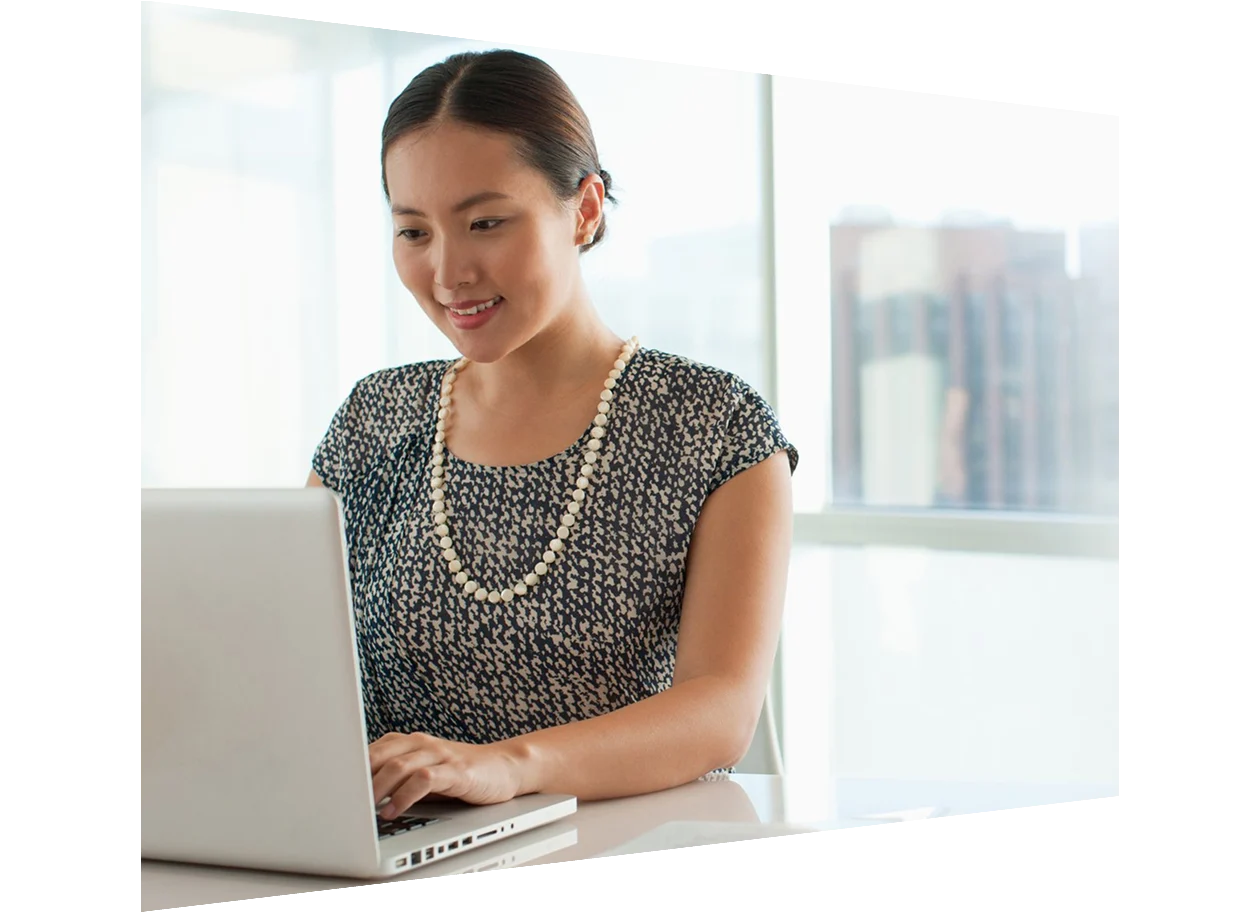Female reviewer working on her laptop and taking notes