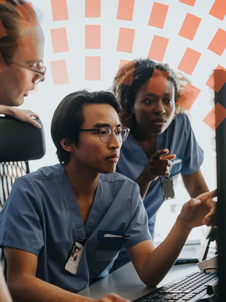 Medical professionals discussing over computer