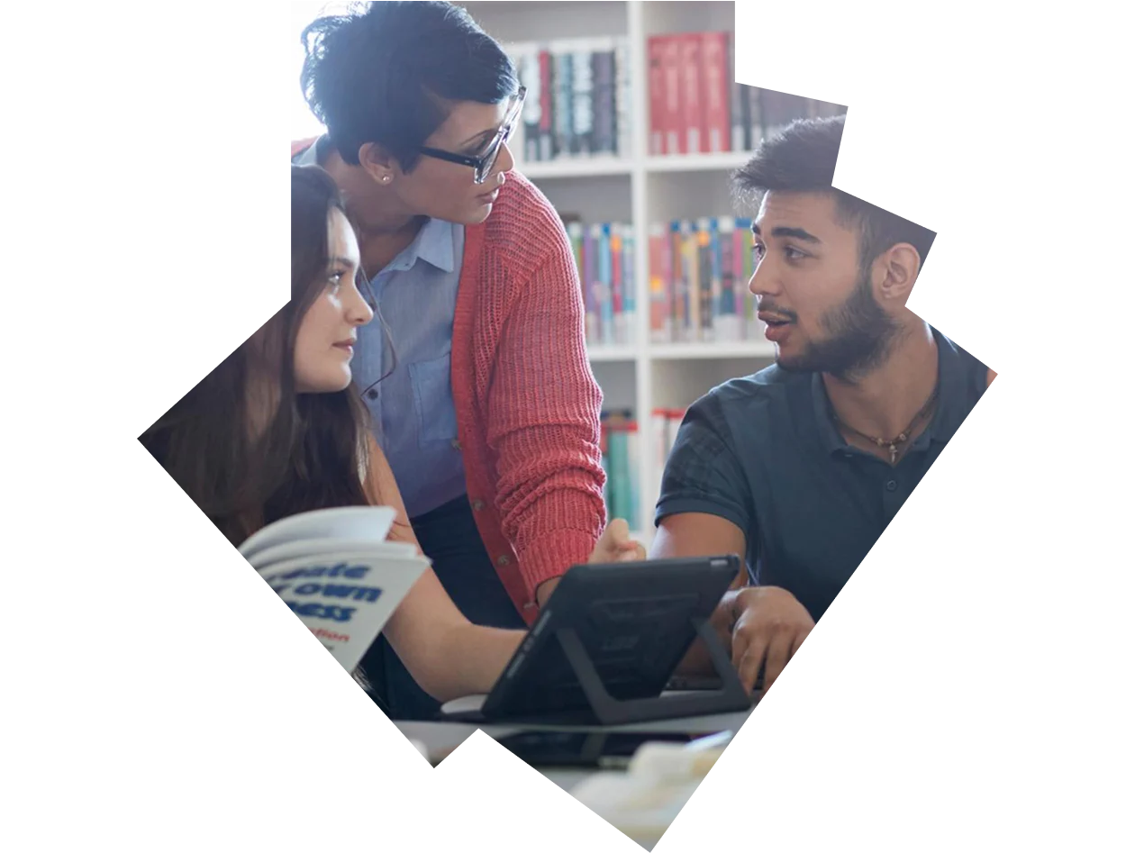 Teacher assisting students in a library
