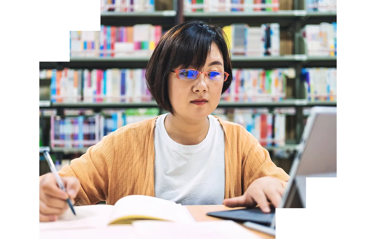 Woman using laptop in library