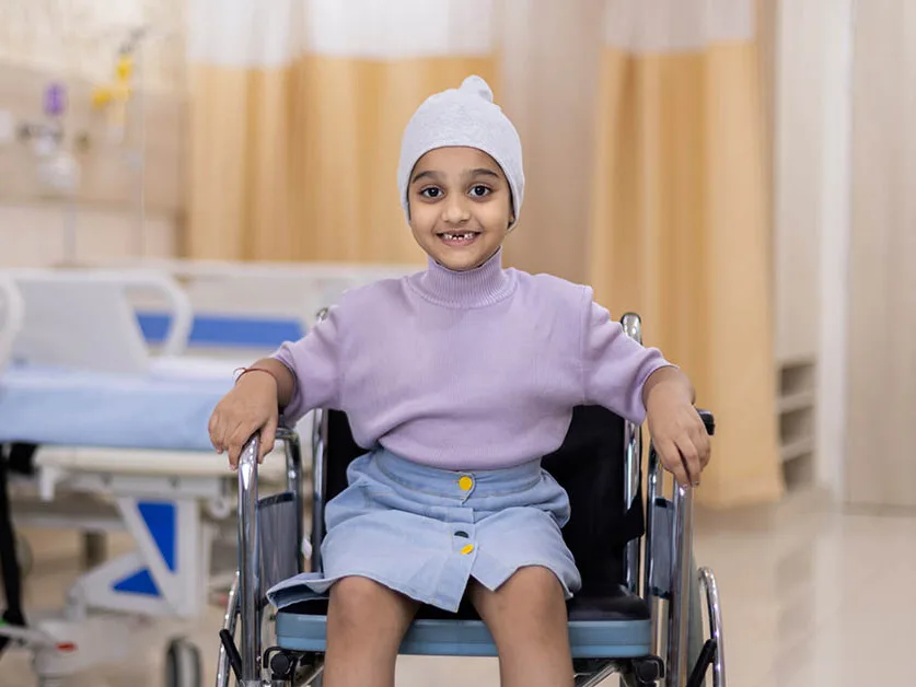 Child in wheelchair, smiling