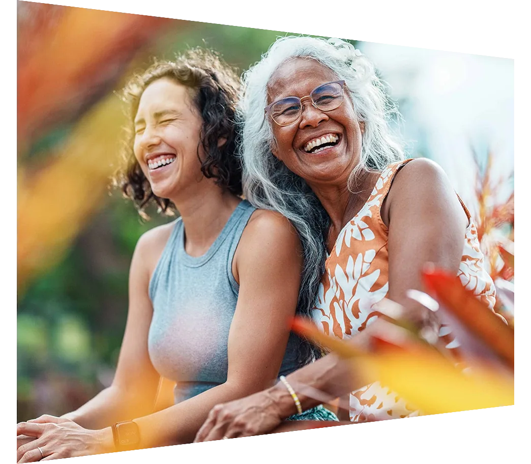 Laughing woman and daughter enjoying time together outdoors