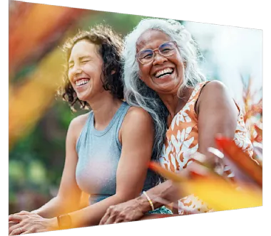 Laughing woman and daughter enjoying time together outdoors