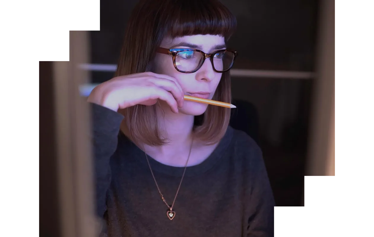 Young woman staring intently at a computer monitor