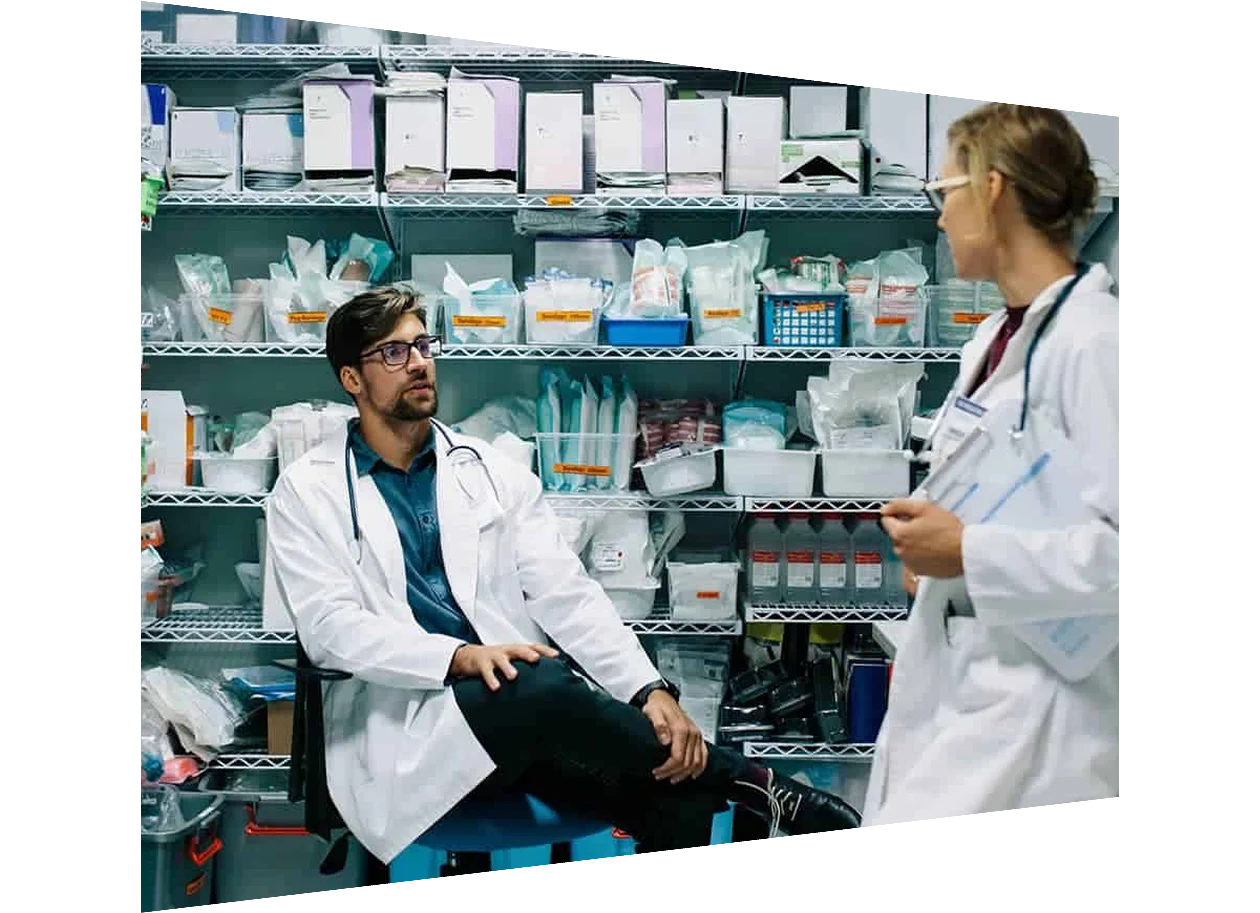 Two pharmacists in the storeroom of a dispensary