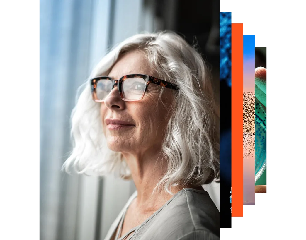 Mature businesswoman in glasses looking out of a window