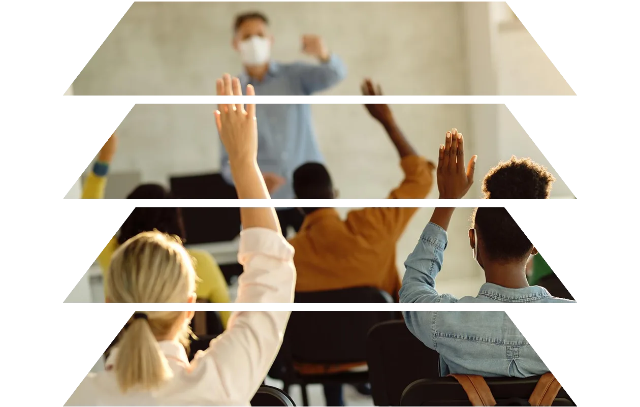 Back view of group of students raising their arms during a class at lecture hall
