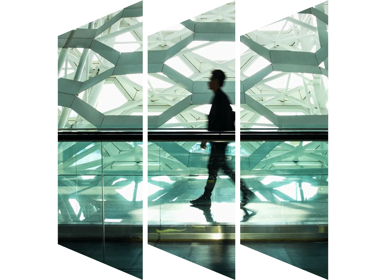 Man walking alone in a modern corridor hallway