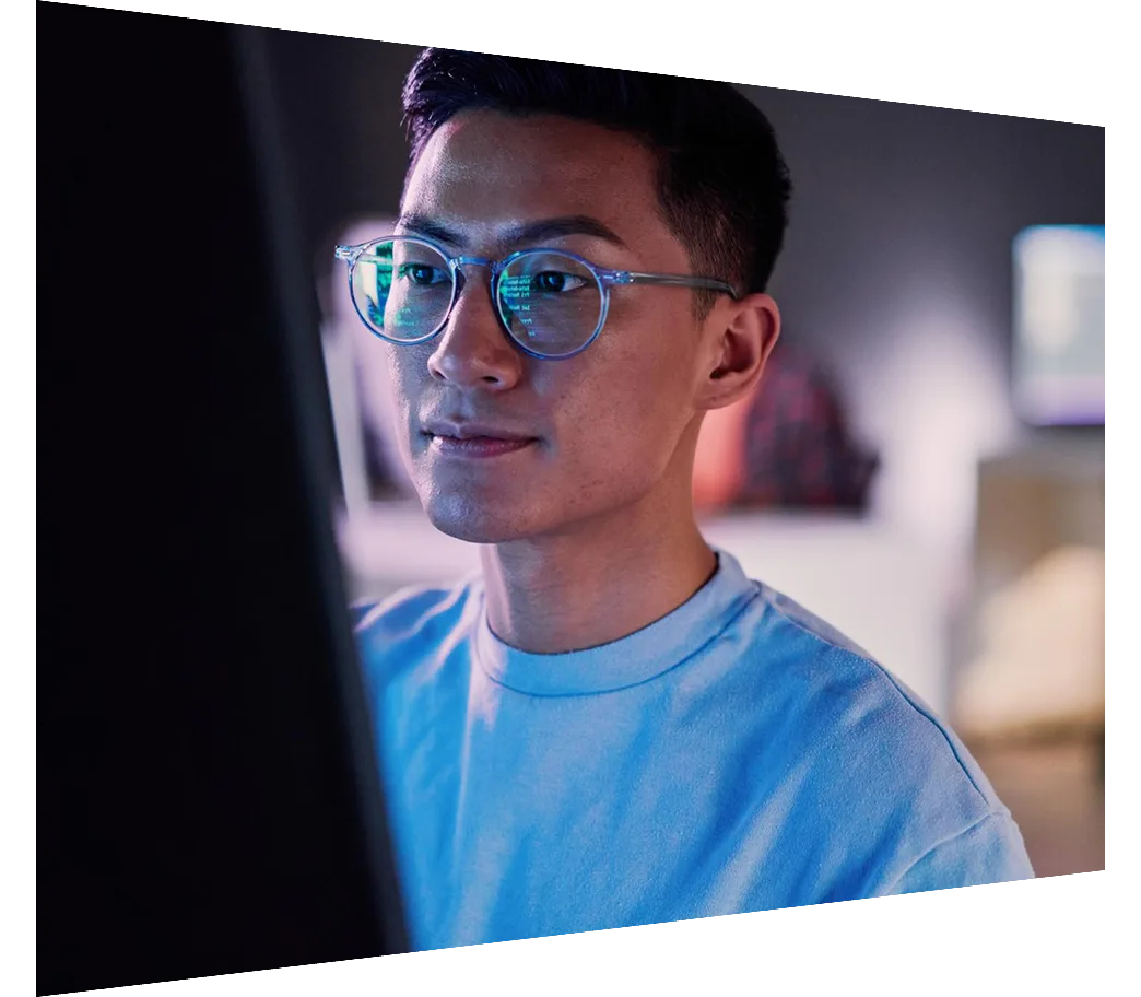 Young Chinese male working on database code at night