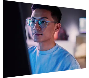 Young Chinese male working on database code at night