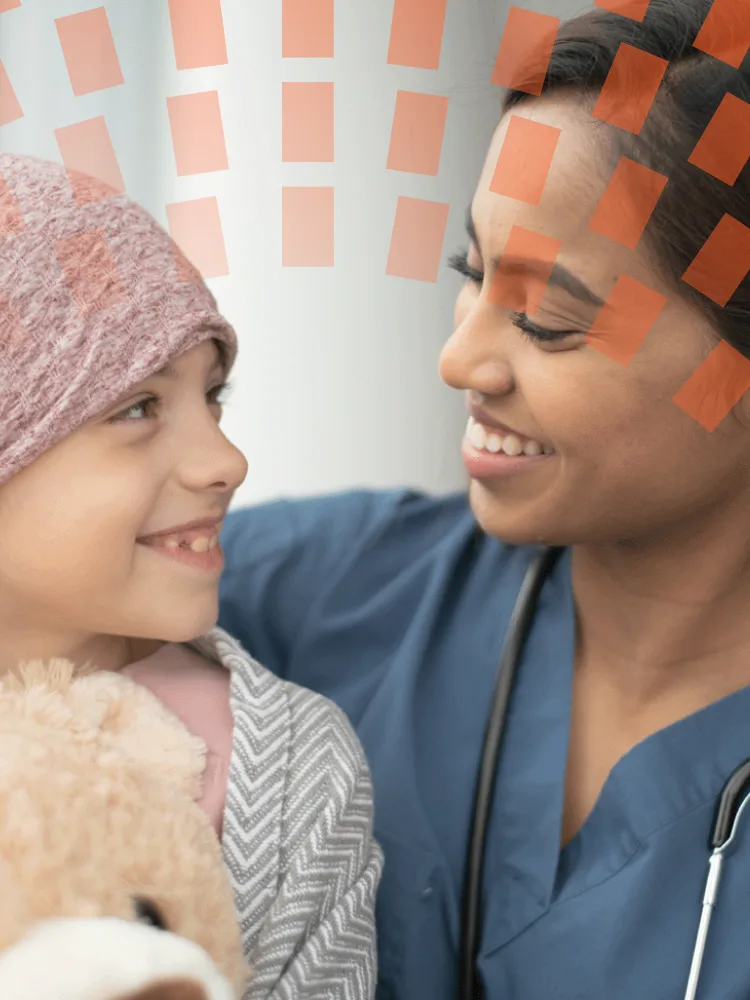 A woman and child sit on a couch, engaged in a warm and happy interaction.