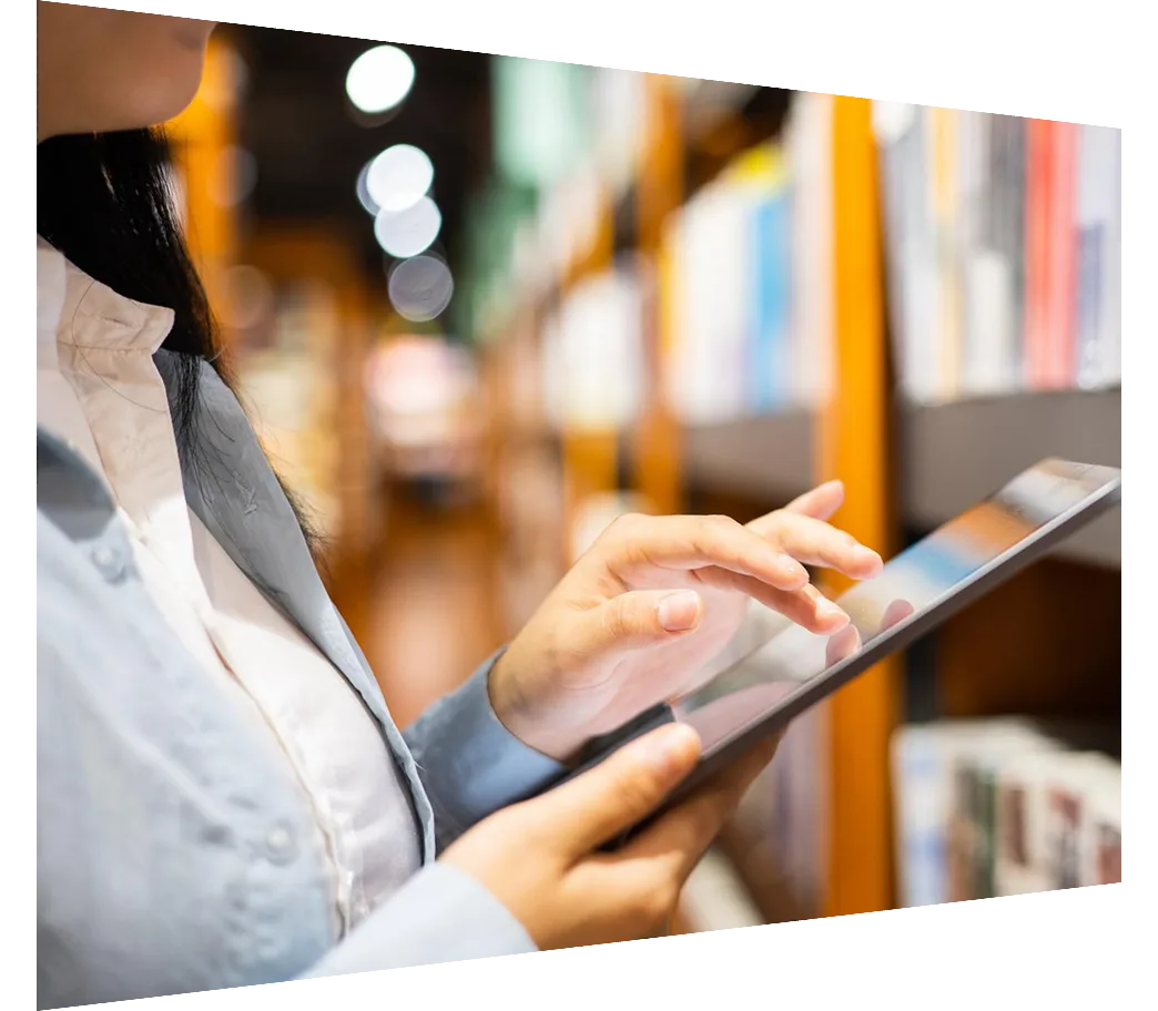Close-up of woman using digital tablet in library