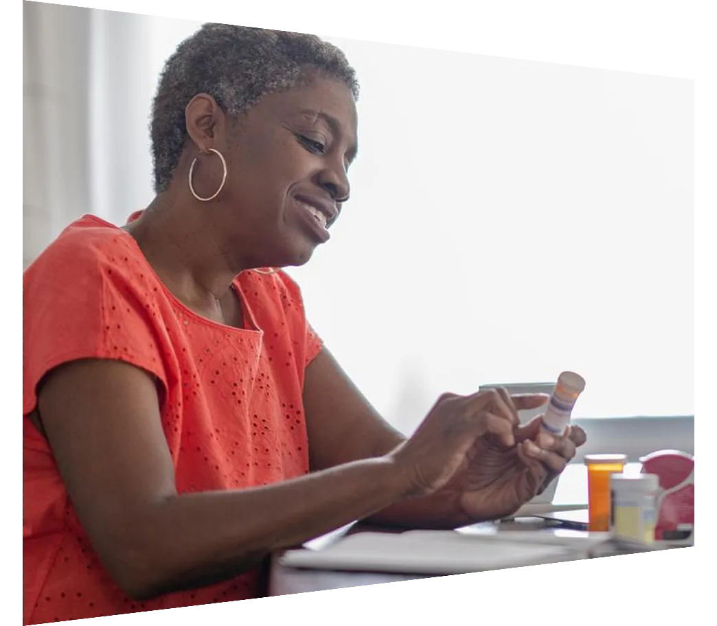 Mature woman looking at her medication