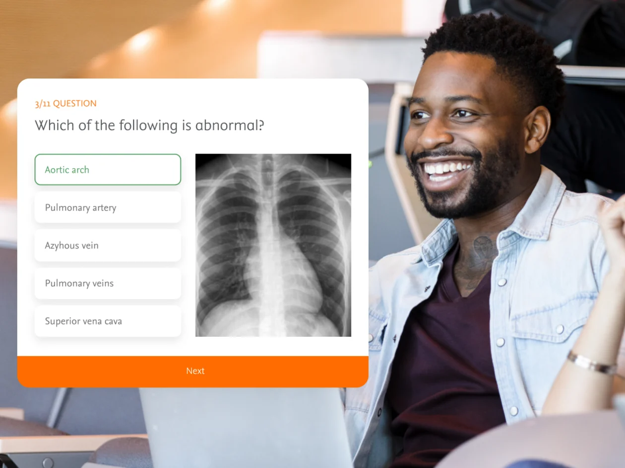 Male student following radiology training on laptop. X-ray photo of a chest with a test question