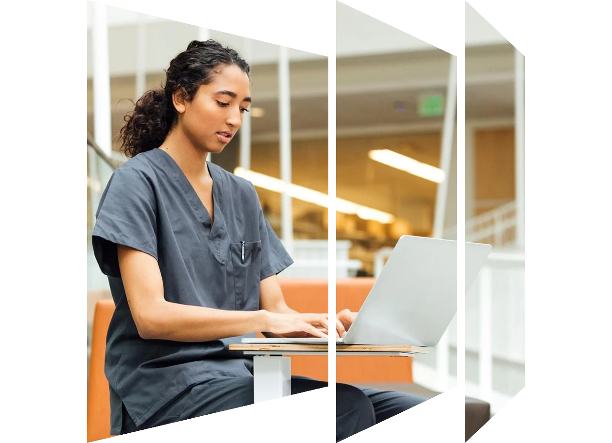 Female nurse working with laptop at desk