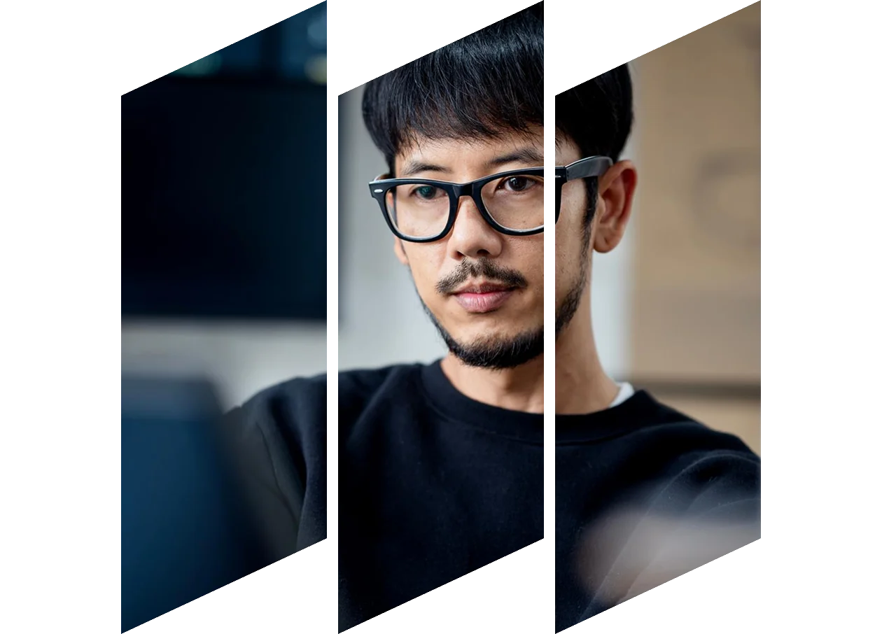 A man with glasses smiling broadly.