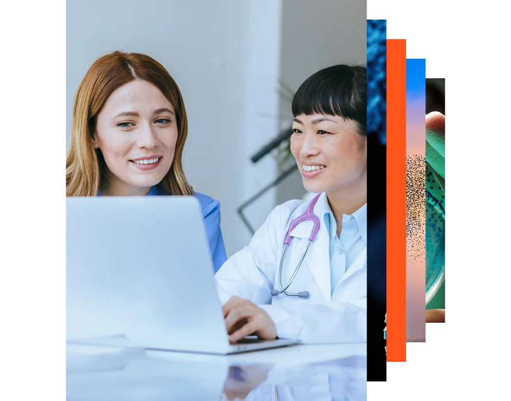 Smiling nurse and doctor looking at a laptop together