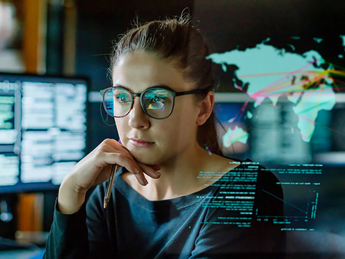 Female data scientist with digital screens