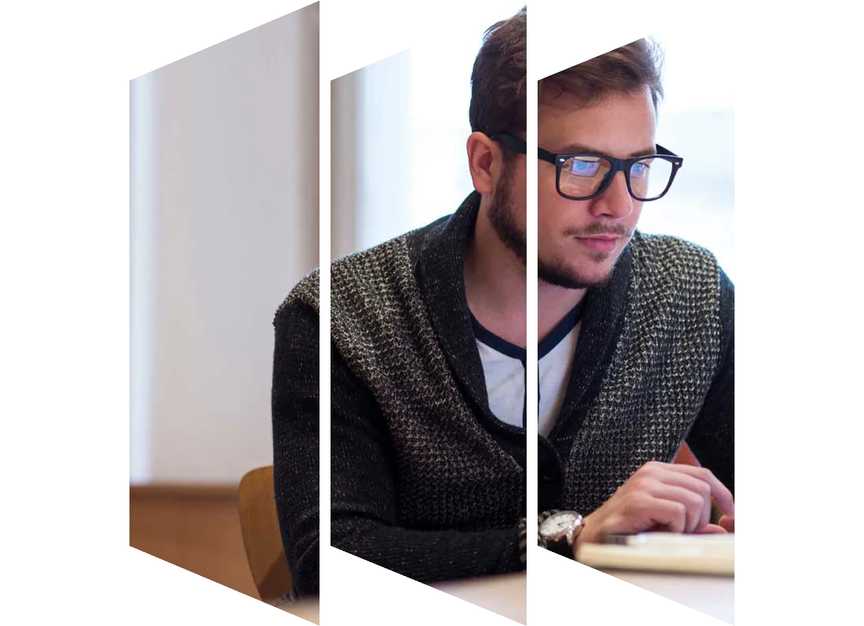 Young male student looking thoughtfully at his laptop