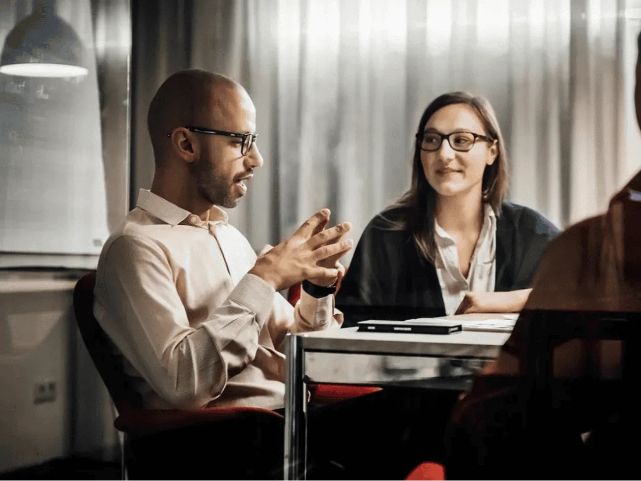 Group of people having a discussion around the table