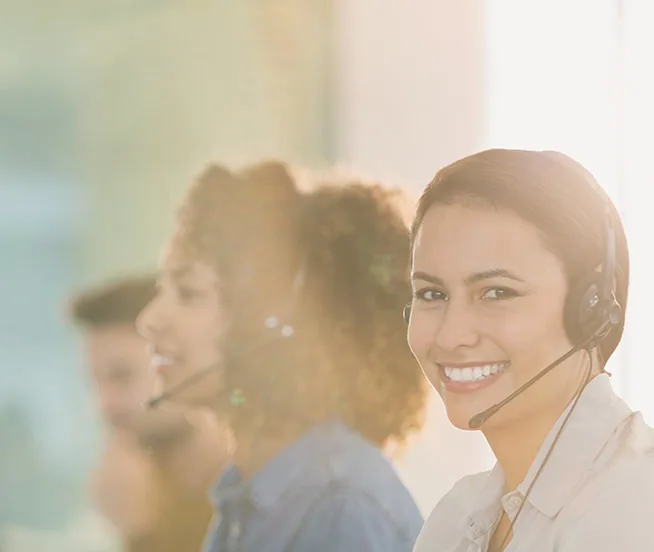 Smiling woman in support team wearing headset