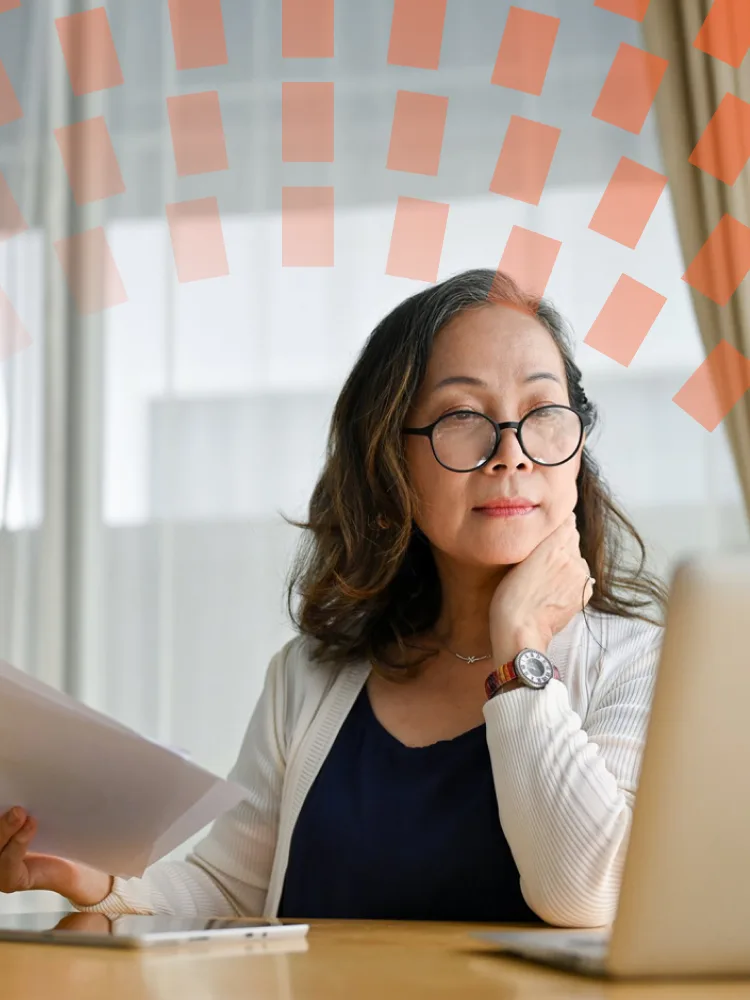 Woman on laptop next to window
