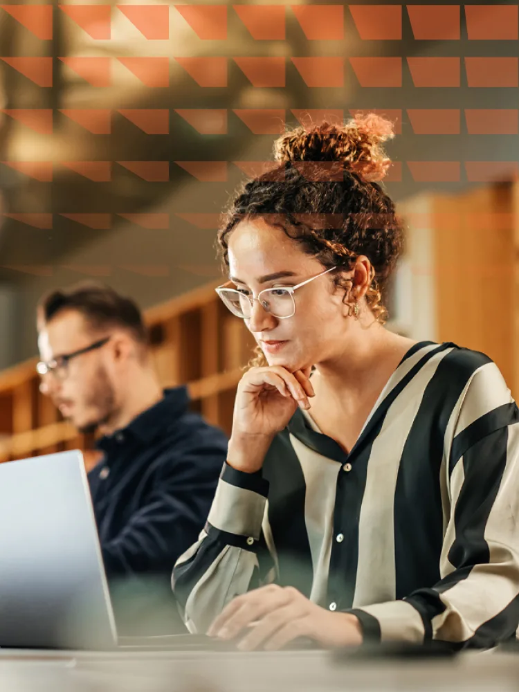 Young female researcher working on computer in a modern bright office