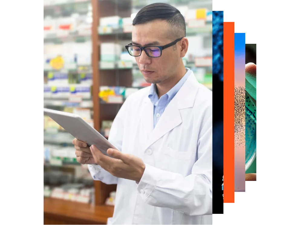 Male pharmacist using a computer in a pharmacy