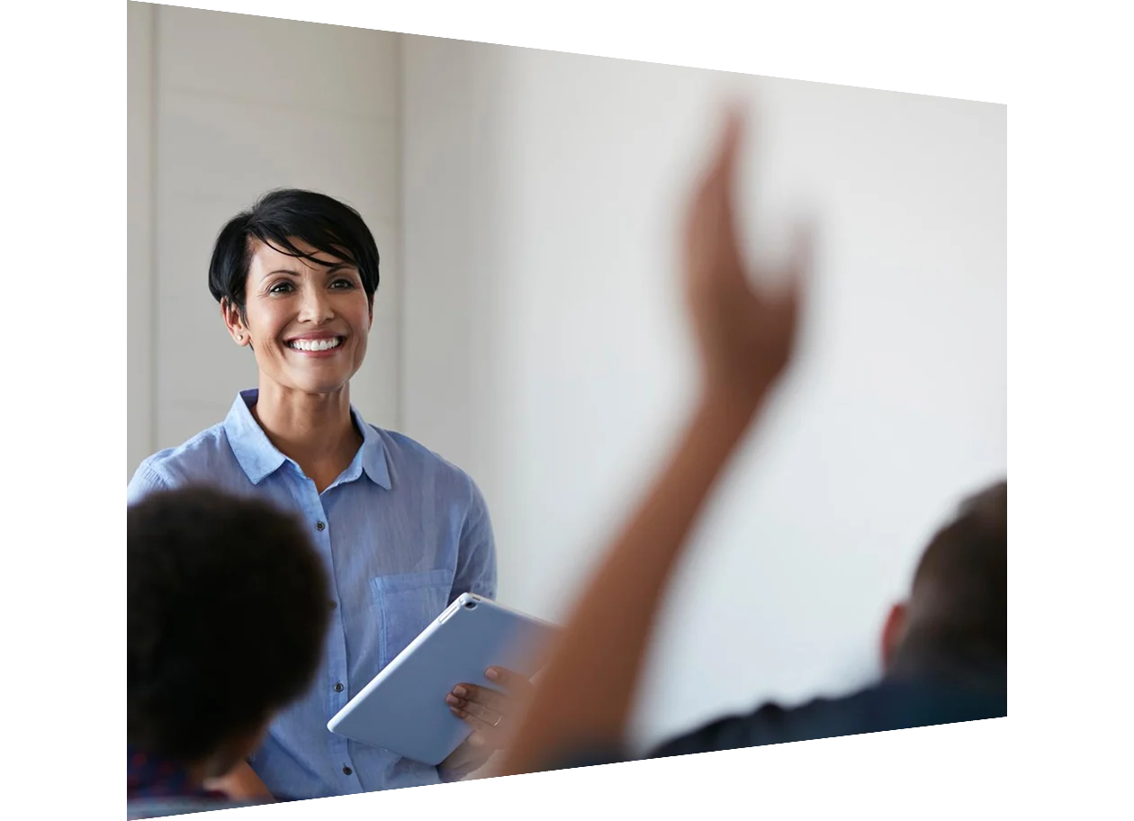 Teacher in front of a student with a raised hand