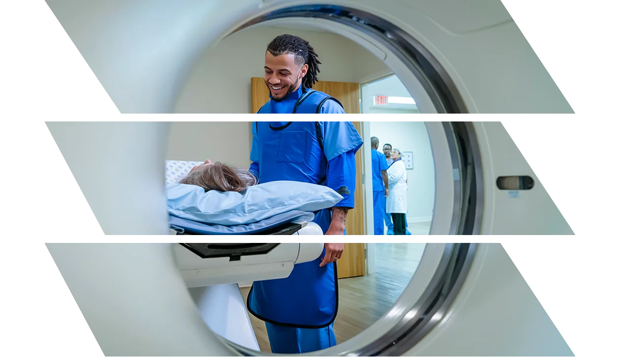Technician talking to patient near scanner