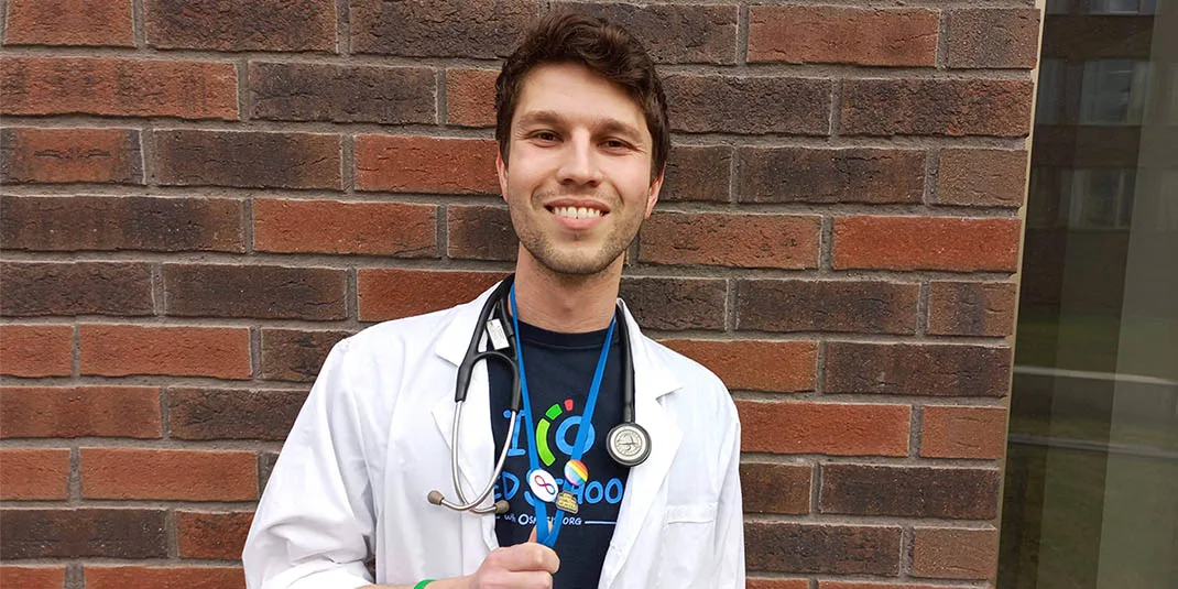 Omer Rott shows his LGBTQ+ and neurodiversity pins. He's 6th-year medical student at Masaryk University in the Czech Republic and a Community Operations Lead in the Osmosis Medical Education Fellowship program at Elsevier.