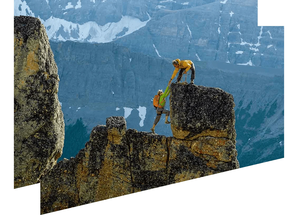 Two climbers reaching summit