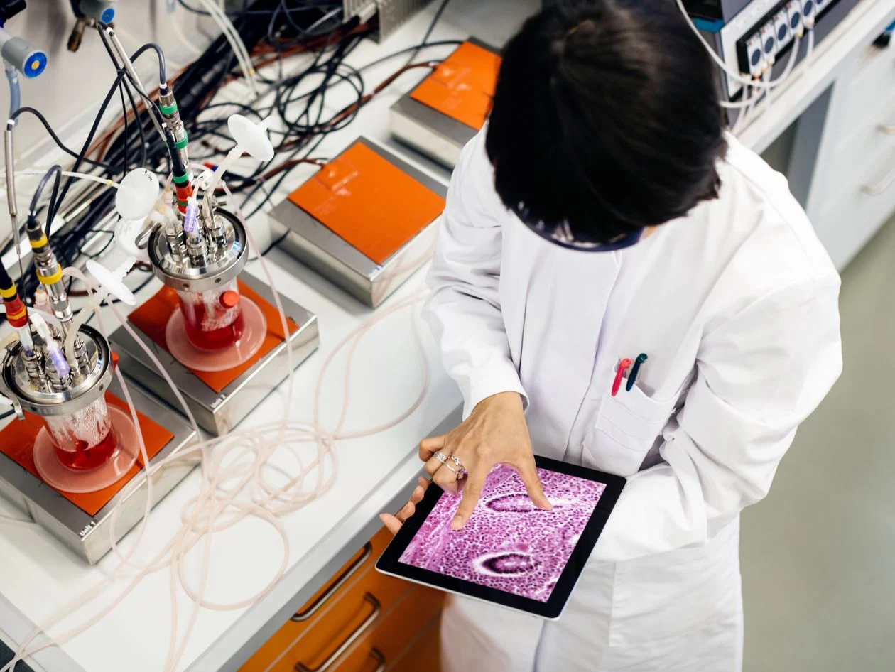 Researcher working in lab with tablet