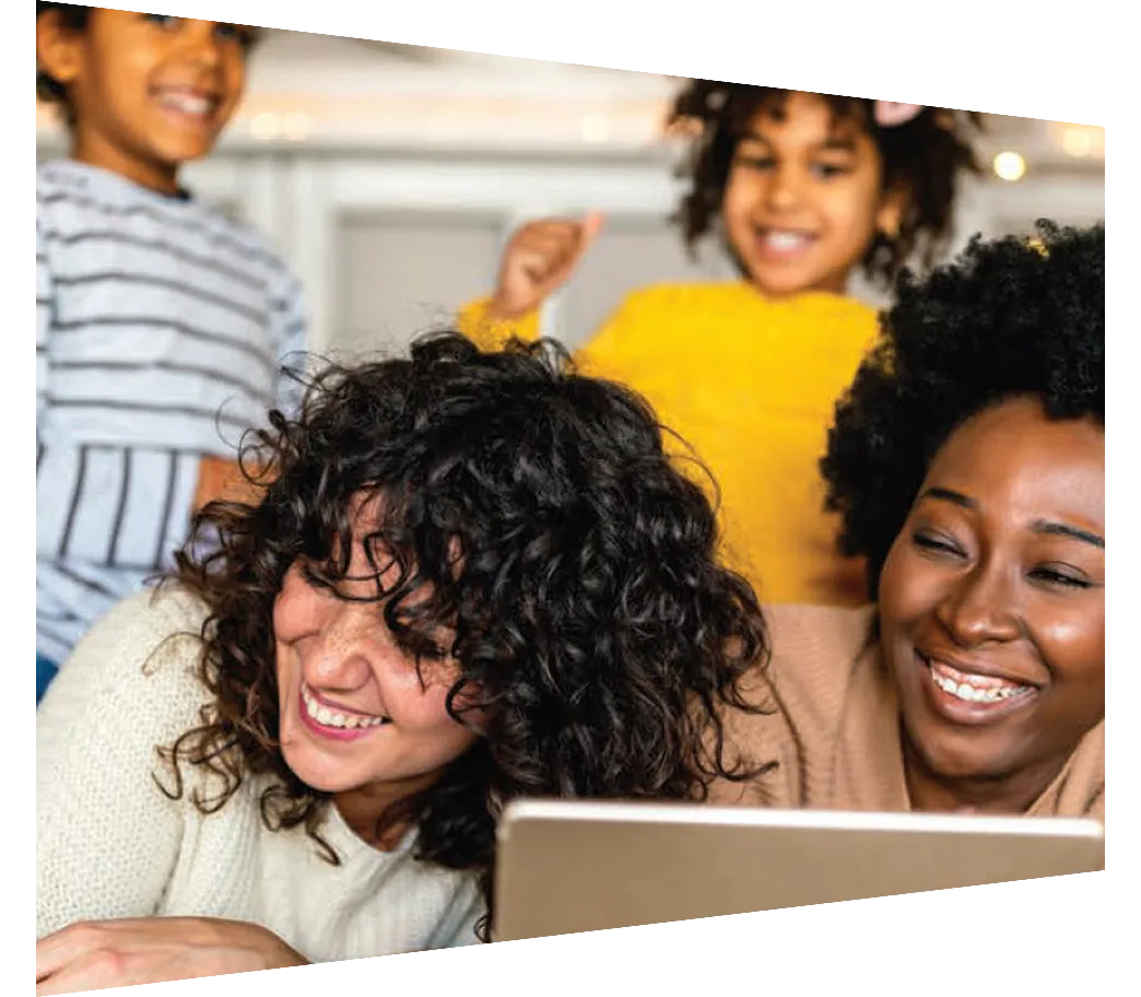 Happy multiethnic women couple having fun with kids at home