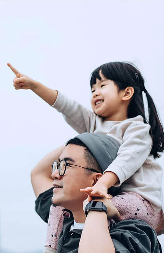 Asian father and daughter looking at the skyline