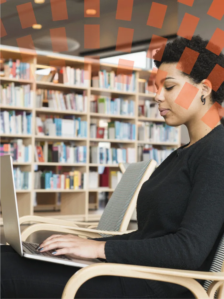 Woman using laptop in library