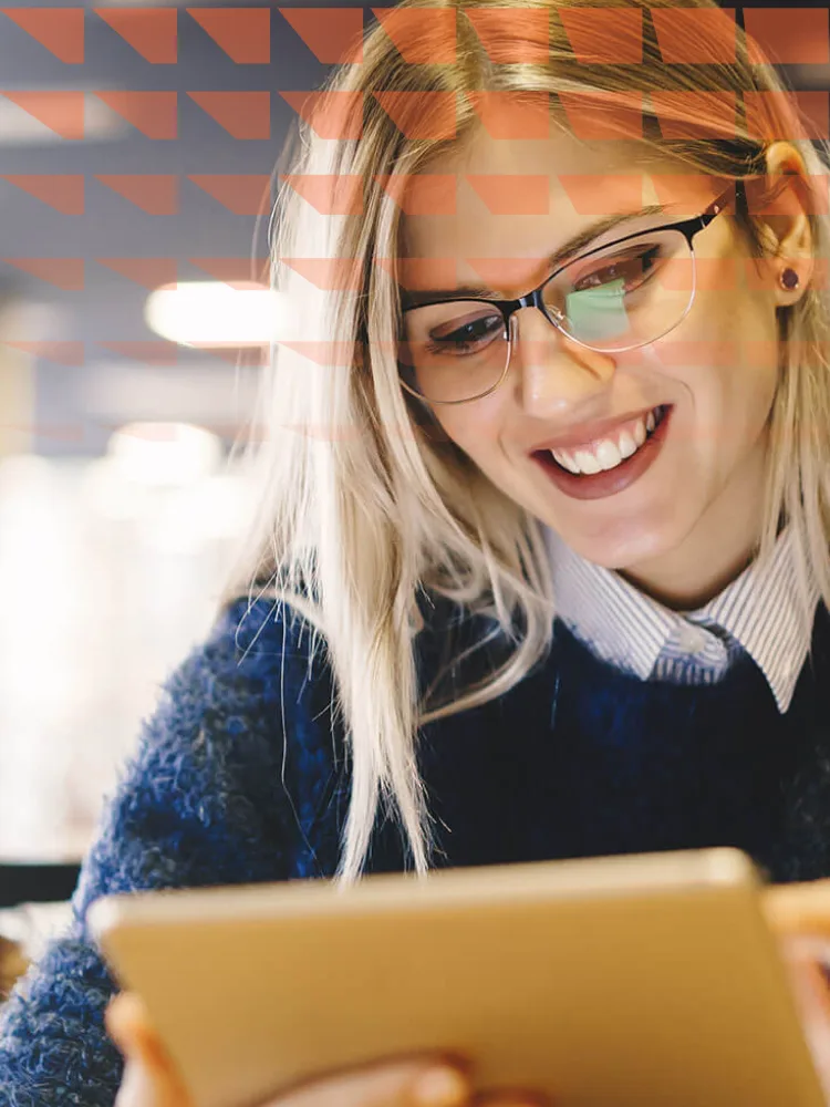 Young female looking at digital tablet in modern office