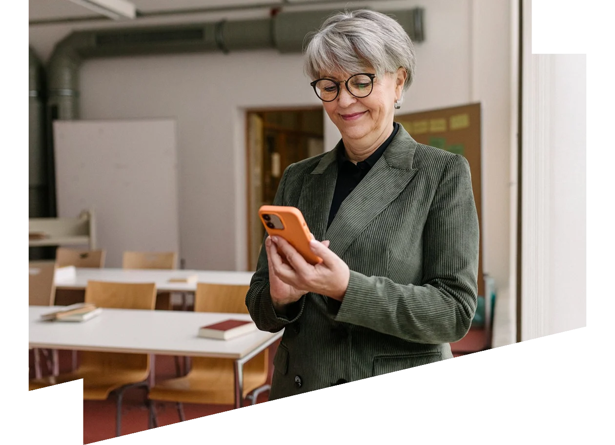 Teacher Using Smartphone In Classroom