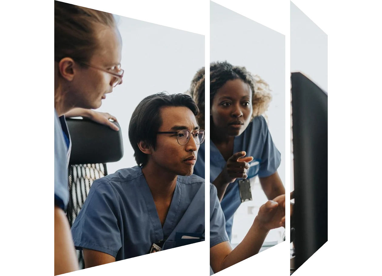 Medical professionals discussing over computer while working in clinic at hospital