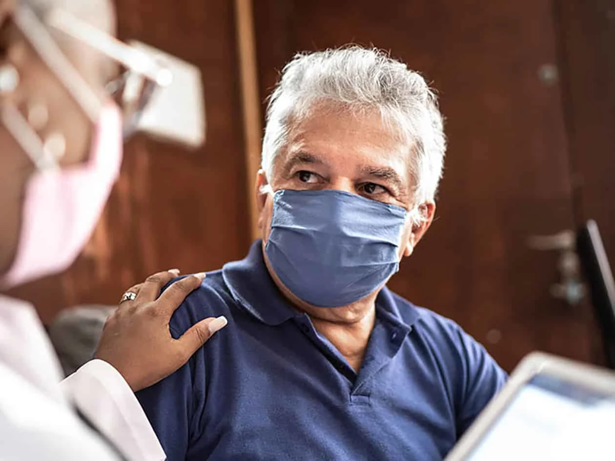 Doctor and patient wearing masks during visit