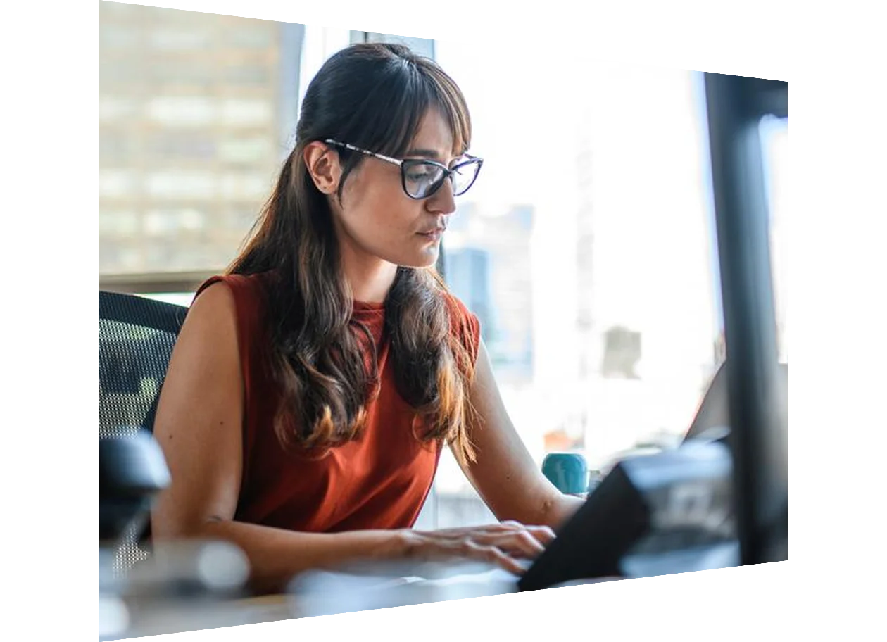 Female author working on laptop in office
