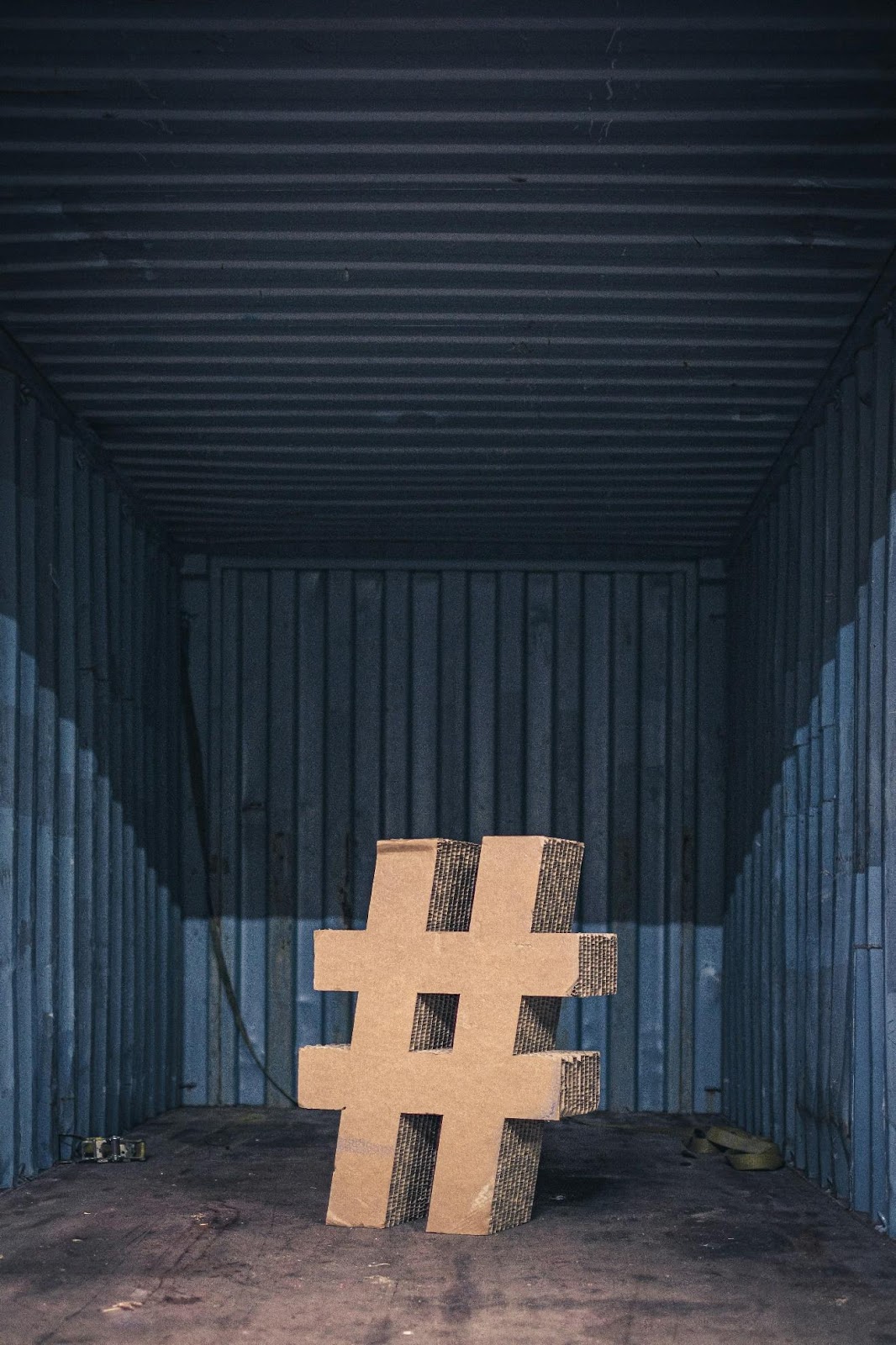 A cardboard hashtag in a container
Description automatically generated