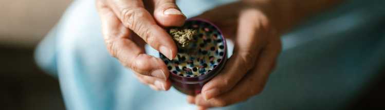 older woman grinding weed
