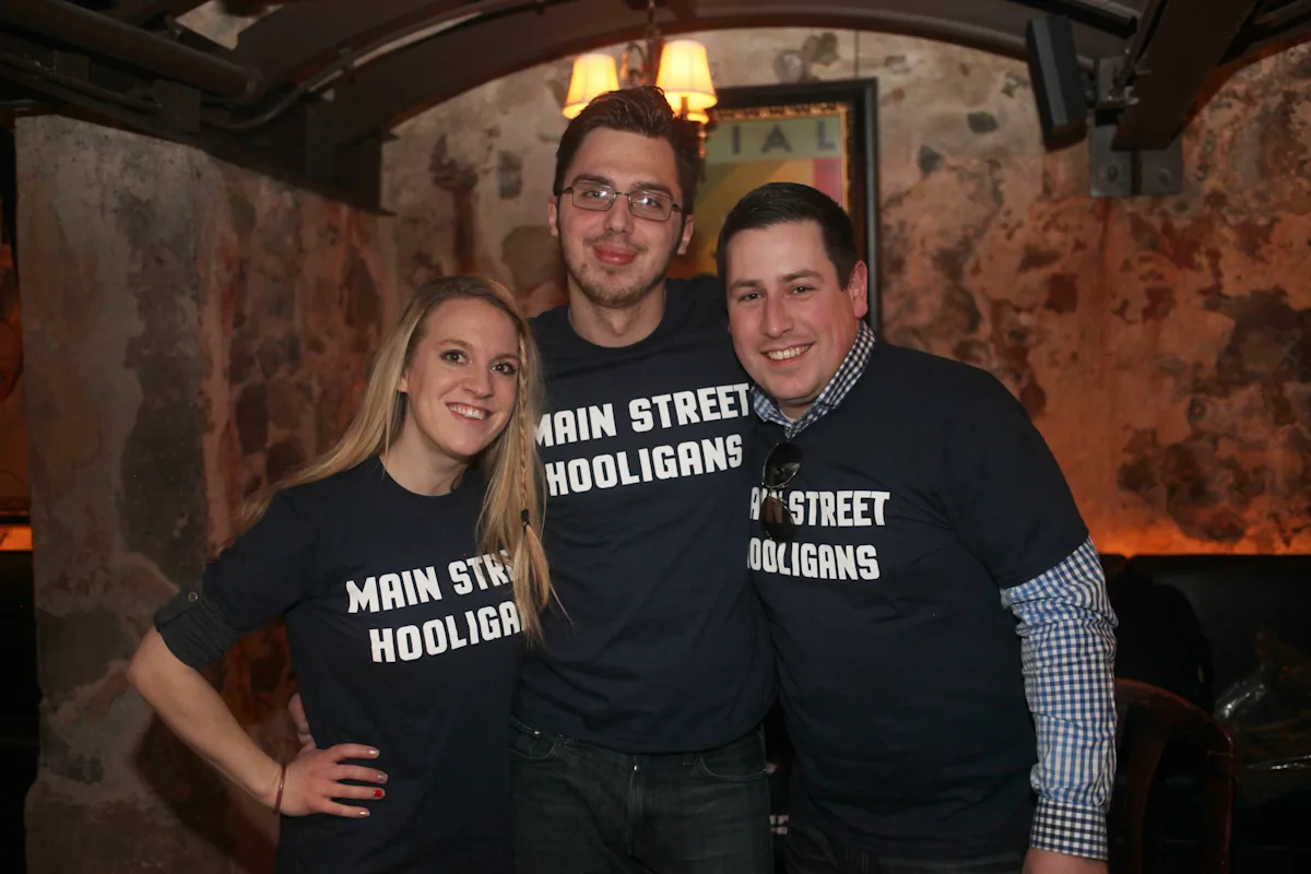 Three early Main Street Hooligans pose together in matching T-shirts
