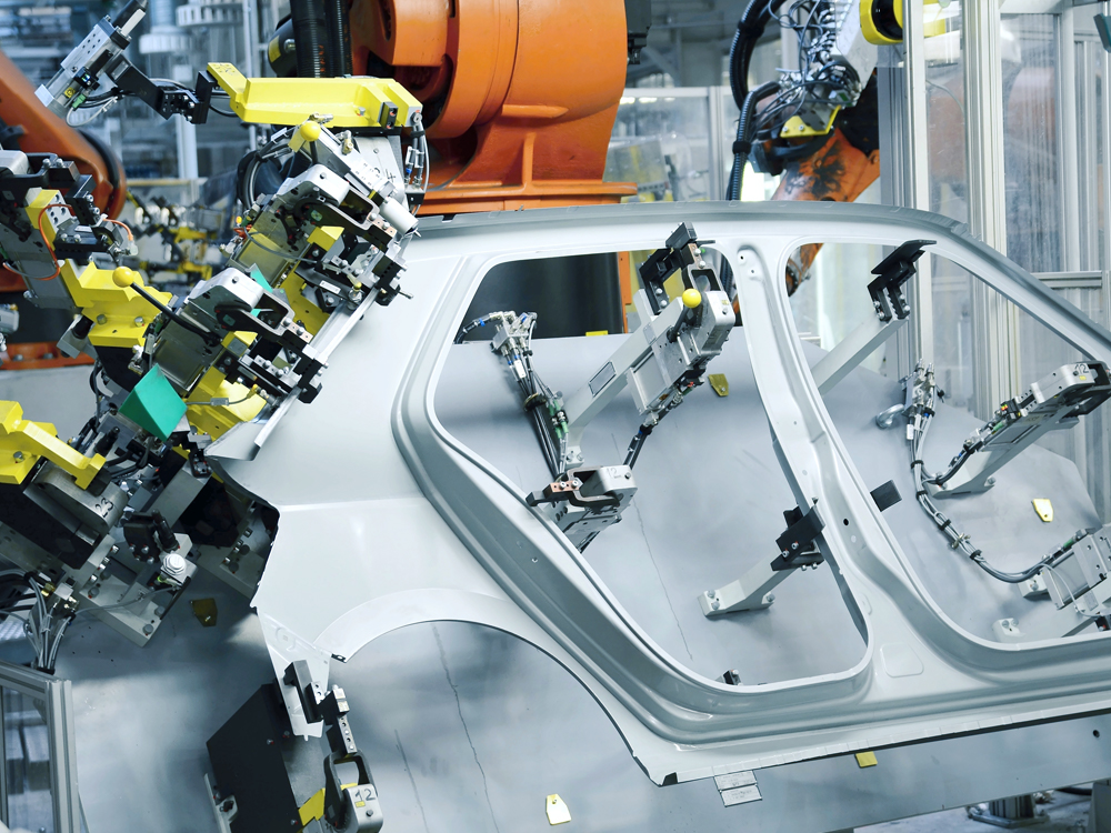 Industrial Robots weld a car door.