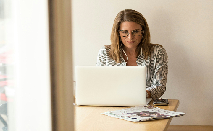 Person working on a laptop at a table