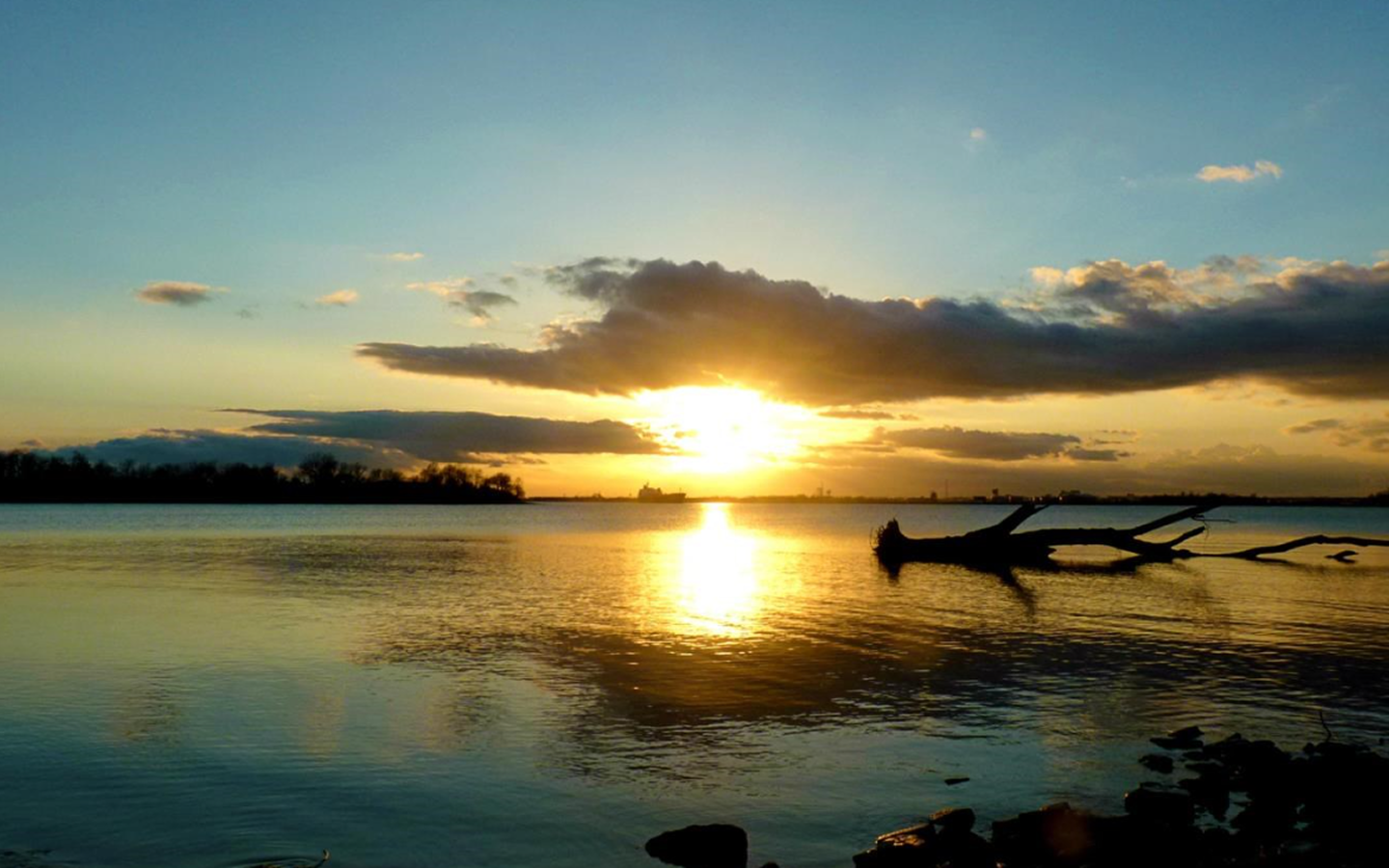 Body of water with a partial cloudy sunset